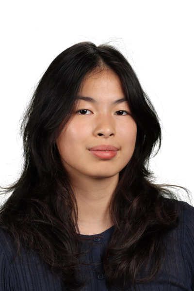 Portrait of a young woman with dark hair against a white background.