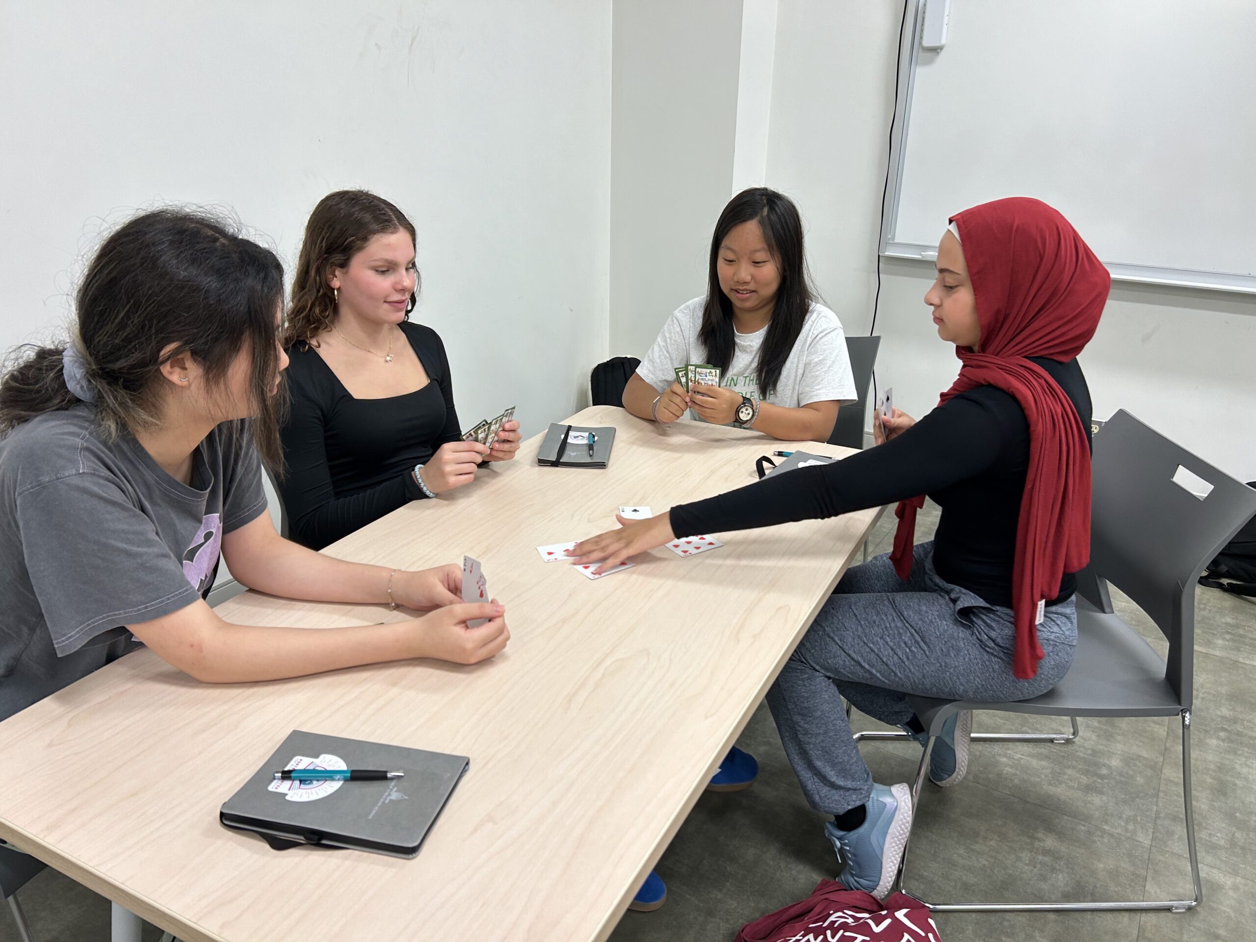 Students at Voices of Leadership using playing cards to work on cooperative strategy