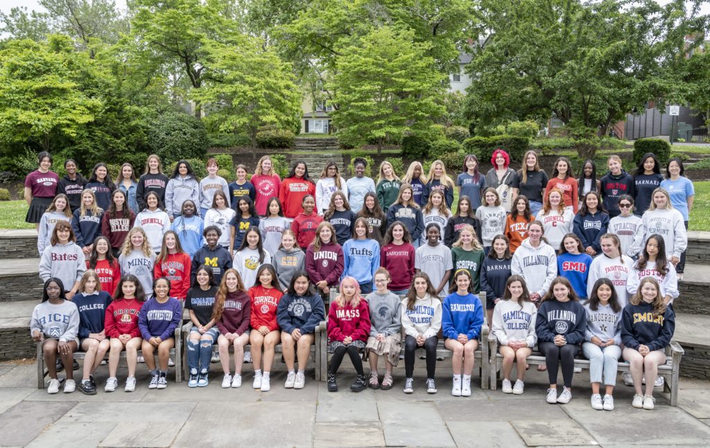 Miss Porter's School seniors posing for group photo wearing sweatshirts from the colleges they were accepted to