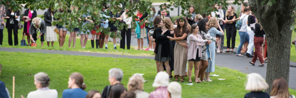 Ancients holding hands and singing Moonbeams at the 175th Reunion